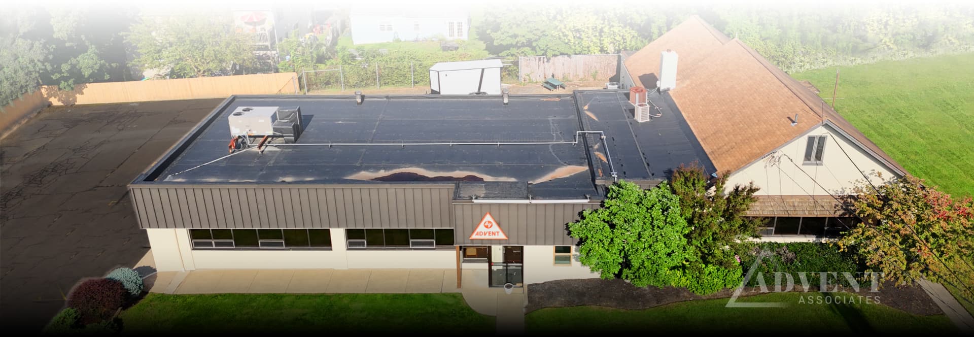 Aerial view of the Advent Associates property at 101 Roesch Avenue showing the building, parking lot and fenced yard