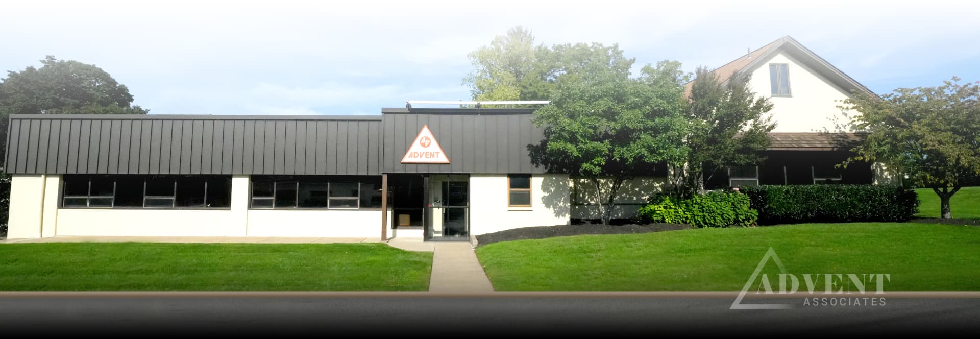 Front entrance of the Advent Associates building at 101 Roesch Avenue seen from the street